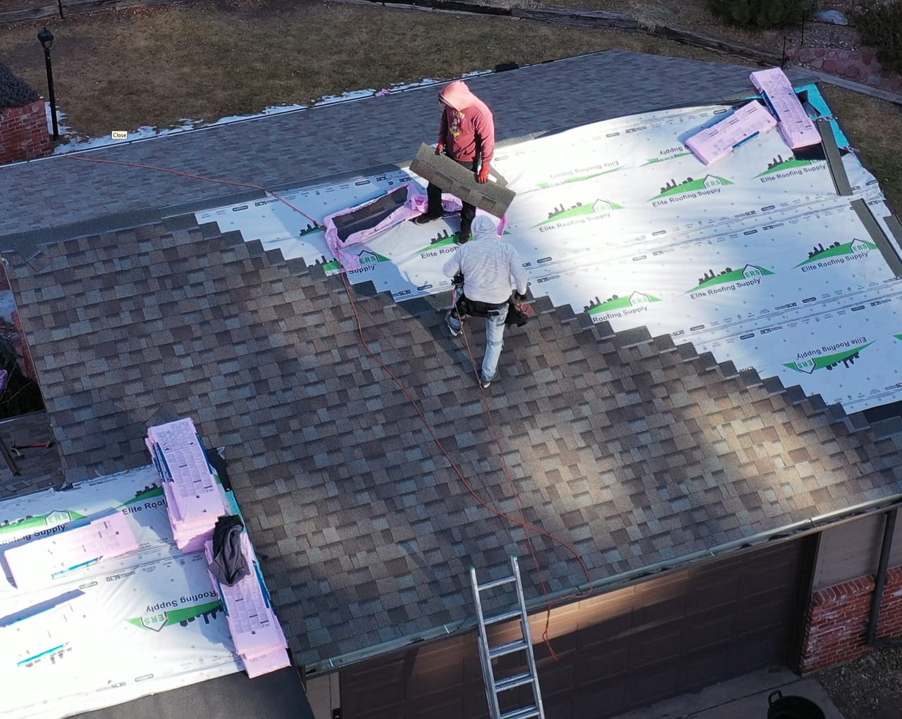 Complete roof replacement with new shingles being installed